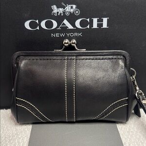 Coach kisslock Black Leather Clutch with White Stitching.